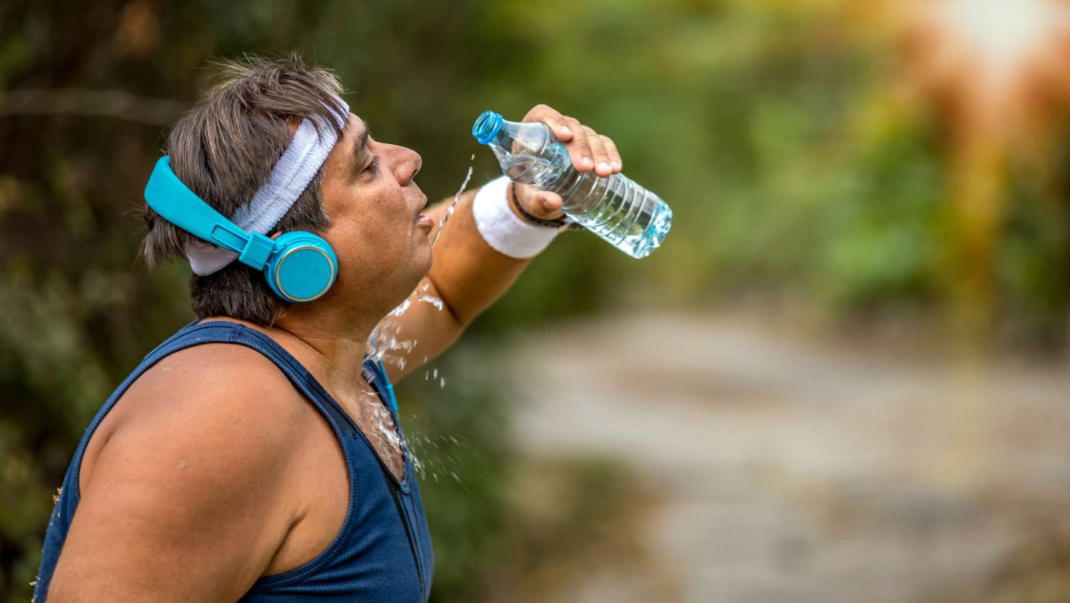 Time out for drinking water . Overweight man breathing heavily and drinking amino acids after intense workouts