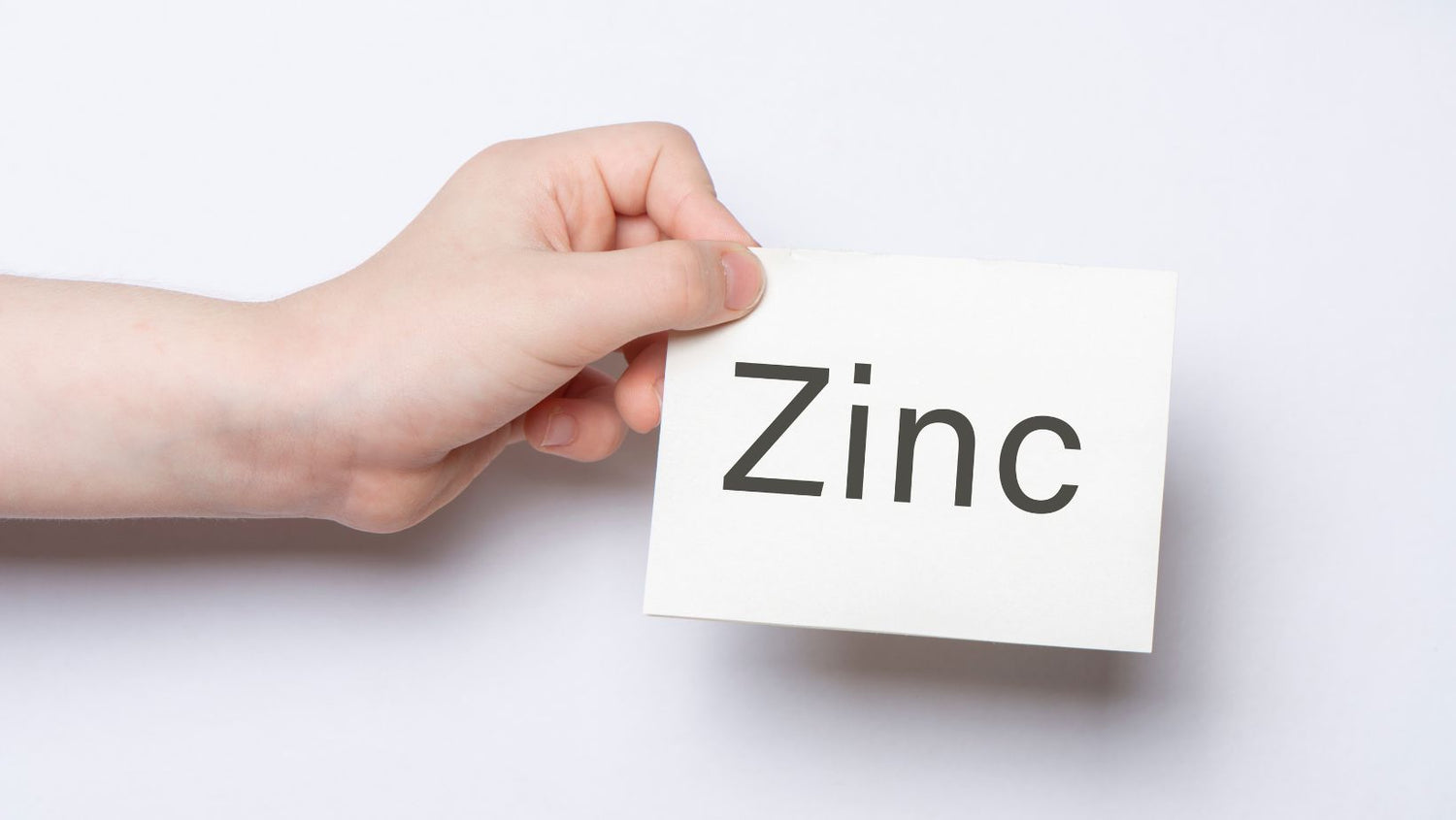 hand holding a card that contains the word Zinc