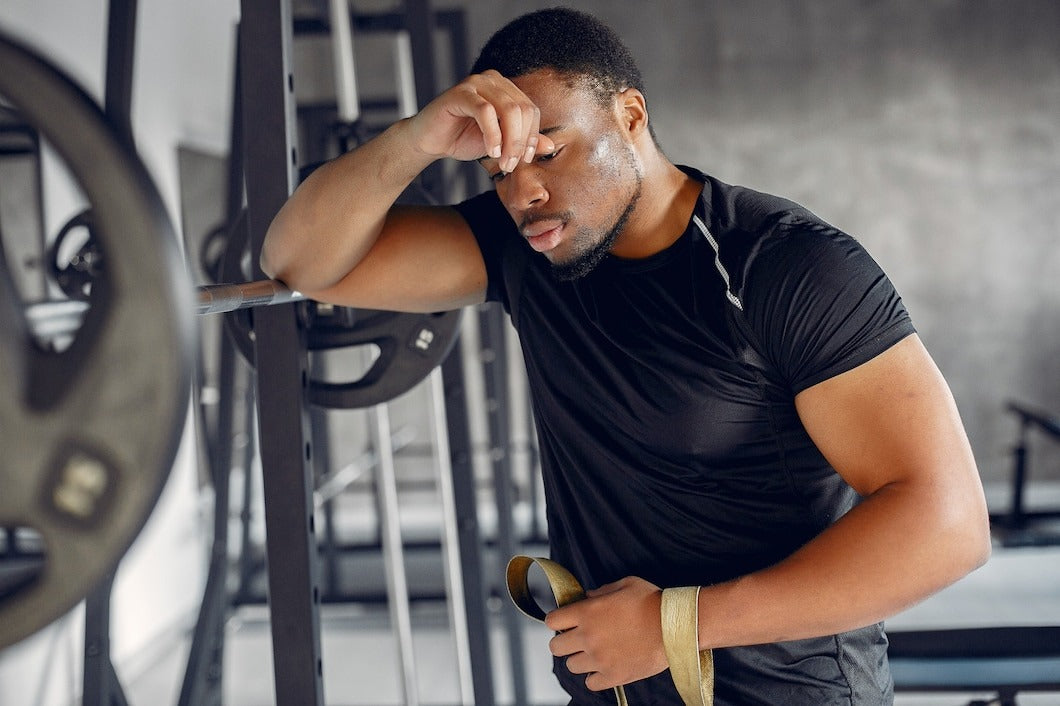 man tired at gym suffering from creatine withdrawel