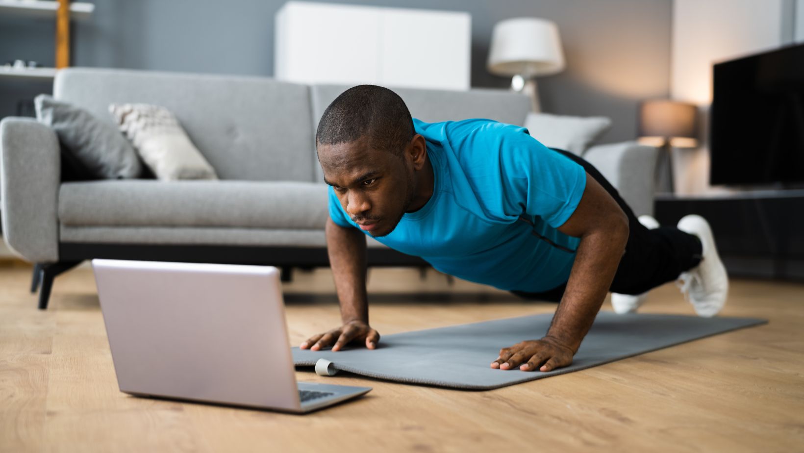 African American Man Doing Online Fitness Pushup Workout