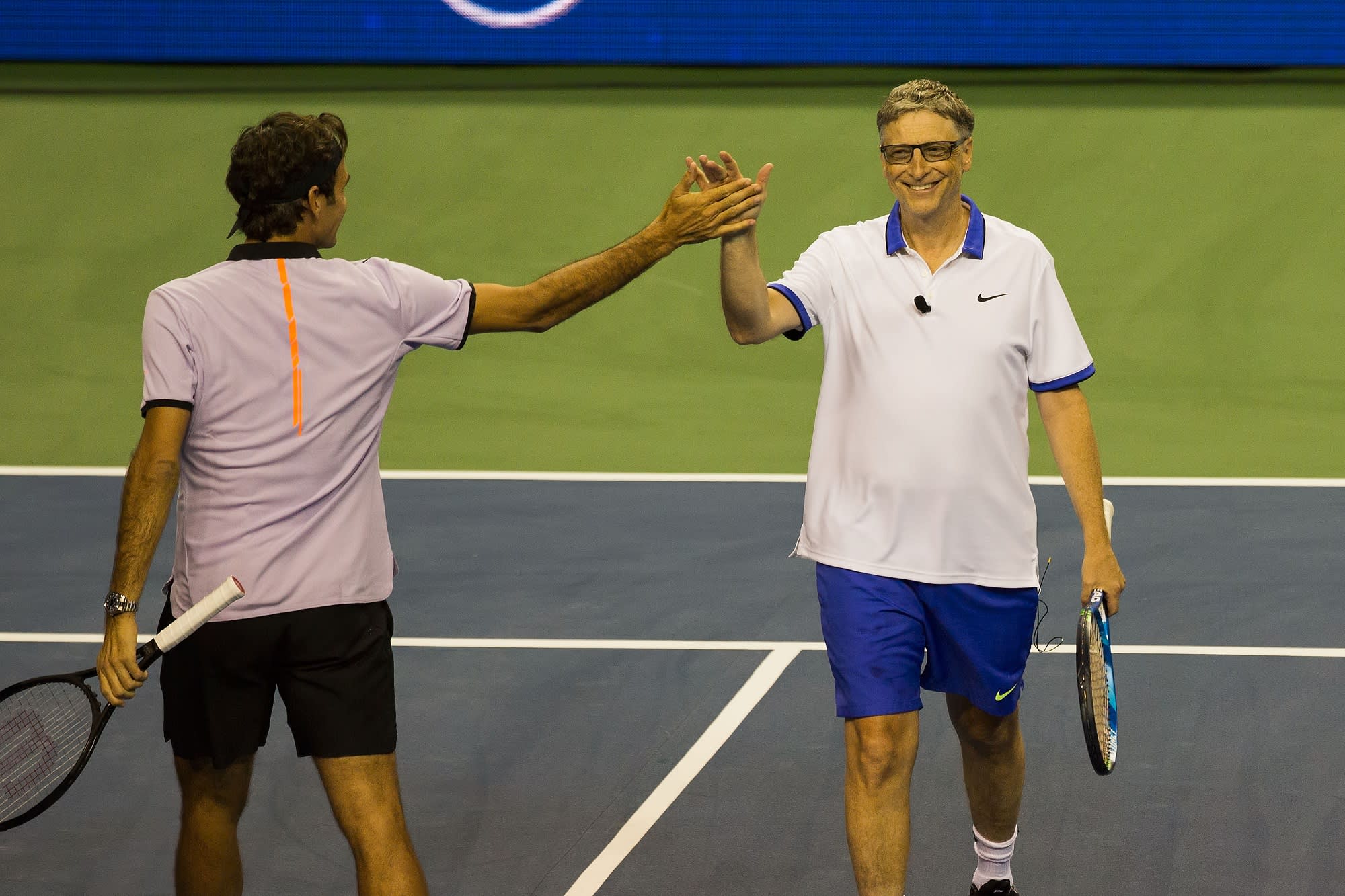 Bill Gates happily playing tennis