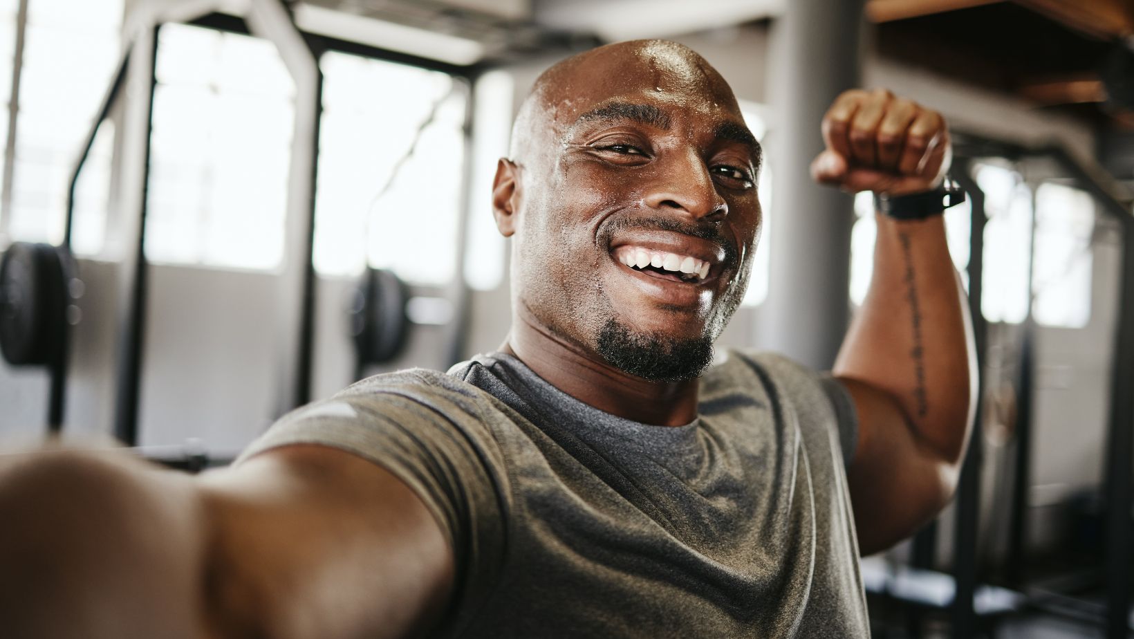 Black man, strong and fitness selfie, gym and exercise portrait, after workout and weight training, happy and flexing arm. Cardio, endurance and smile