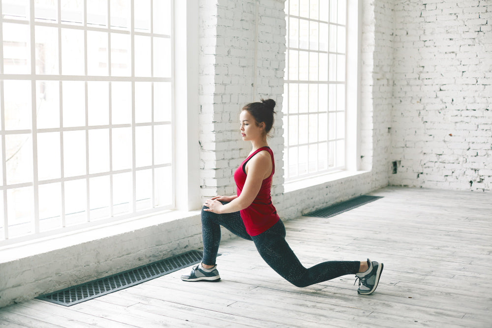 Confident determined student girl with hair knot doing physical workout indoors before university.