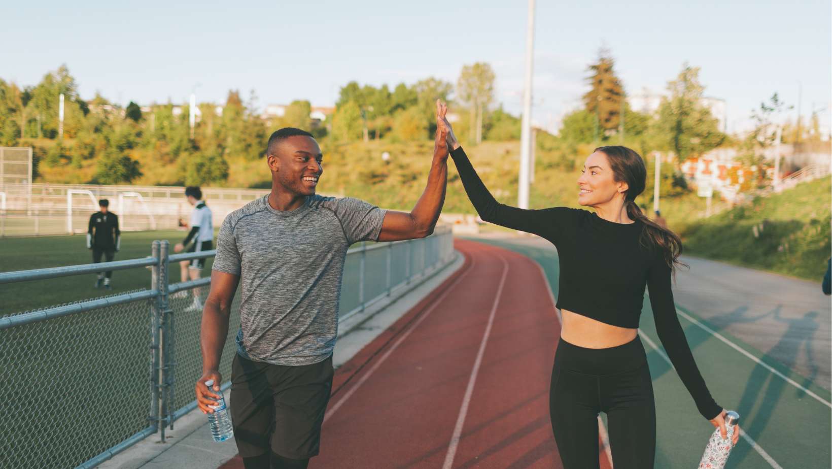Couple Exercising in the Running Track