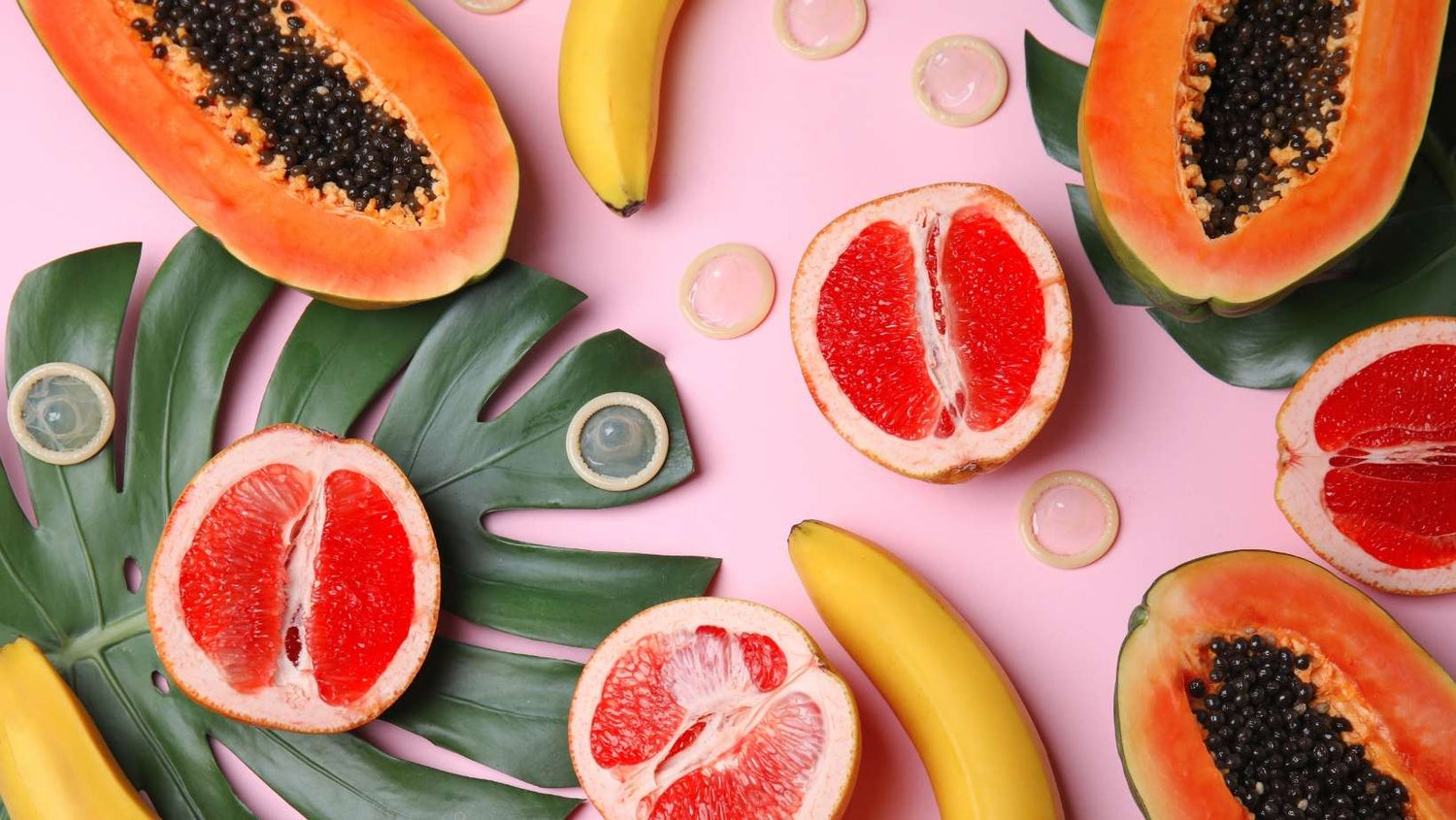 Flat Lay Composition with Condoms and Exotic Fruits on Pink Background. Concept