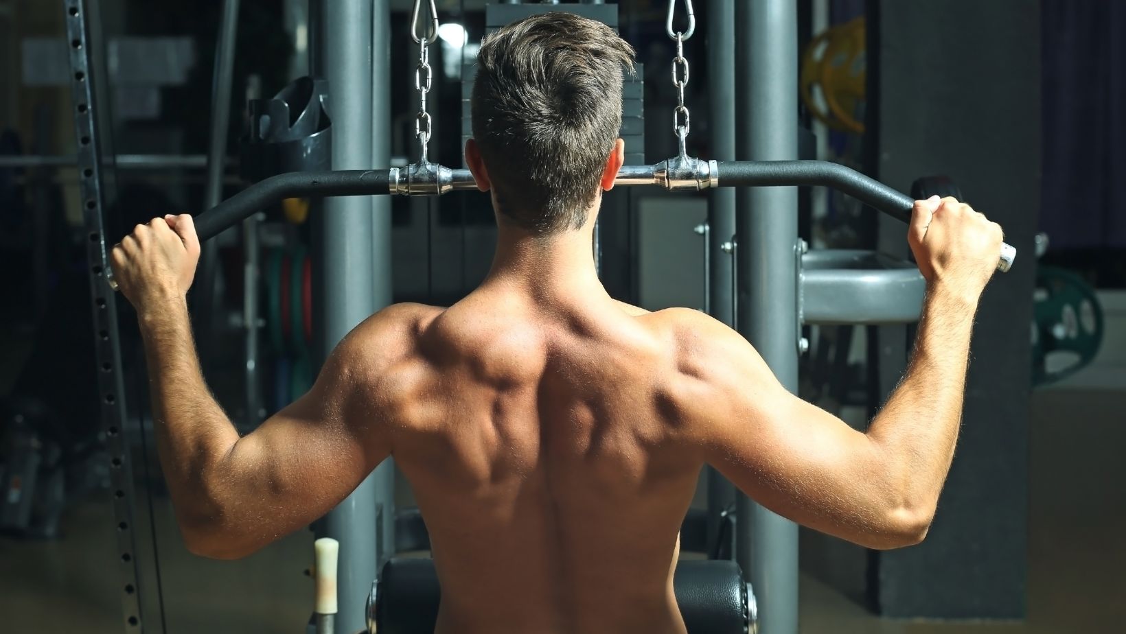 Man Training Back Muscles in Gym