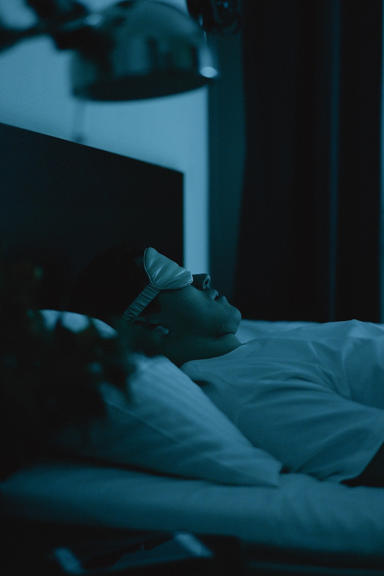 Man Wearing a Sleep Mask Lying on Bed