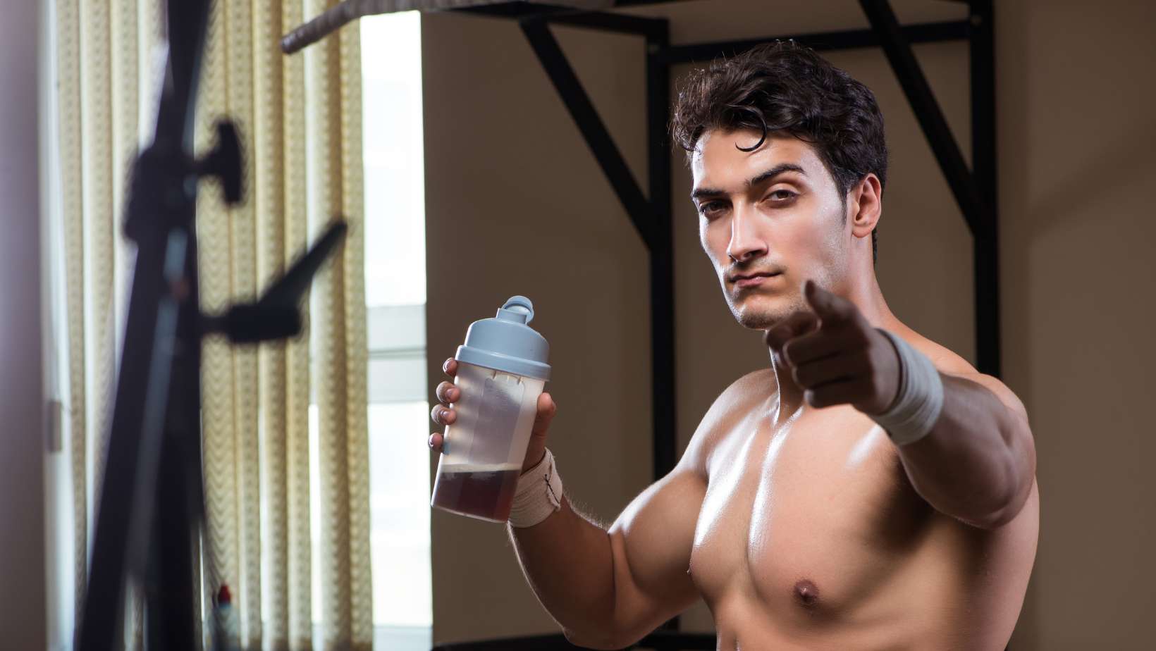 Man with Nutrient Supplements in Sports Gym