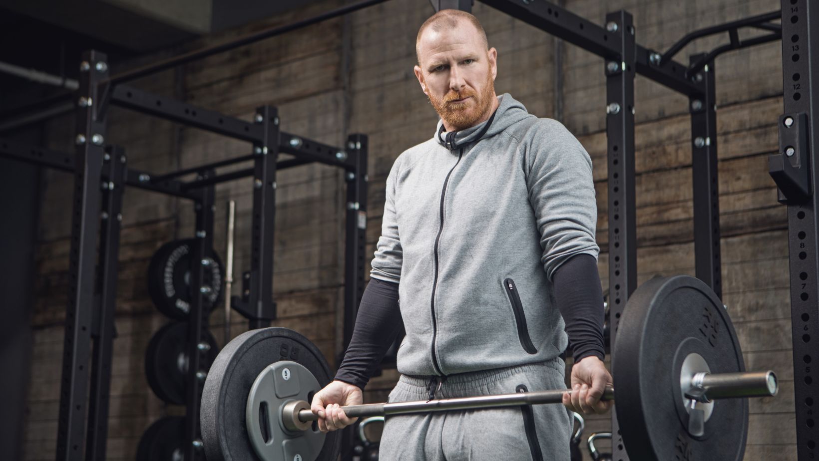Middle Aged Redhead Handsome Man working out in Gym Setting