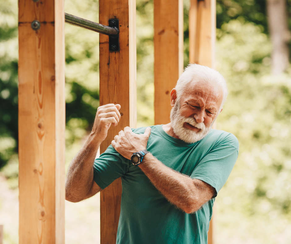 Senior man suffering with shoulder pain during workout