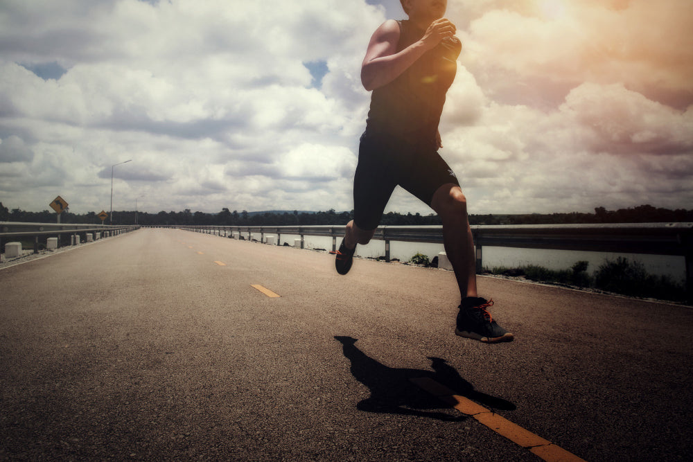 man sprinting on a road