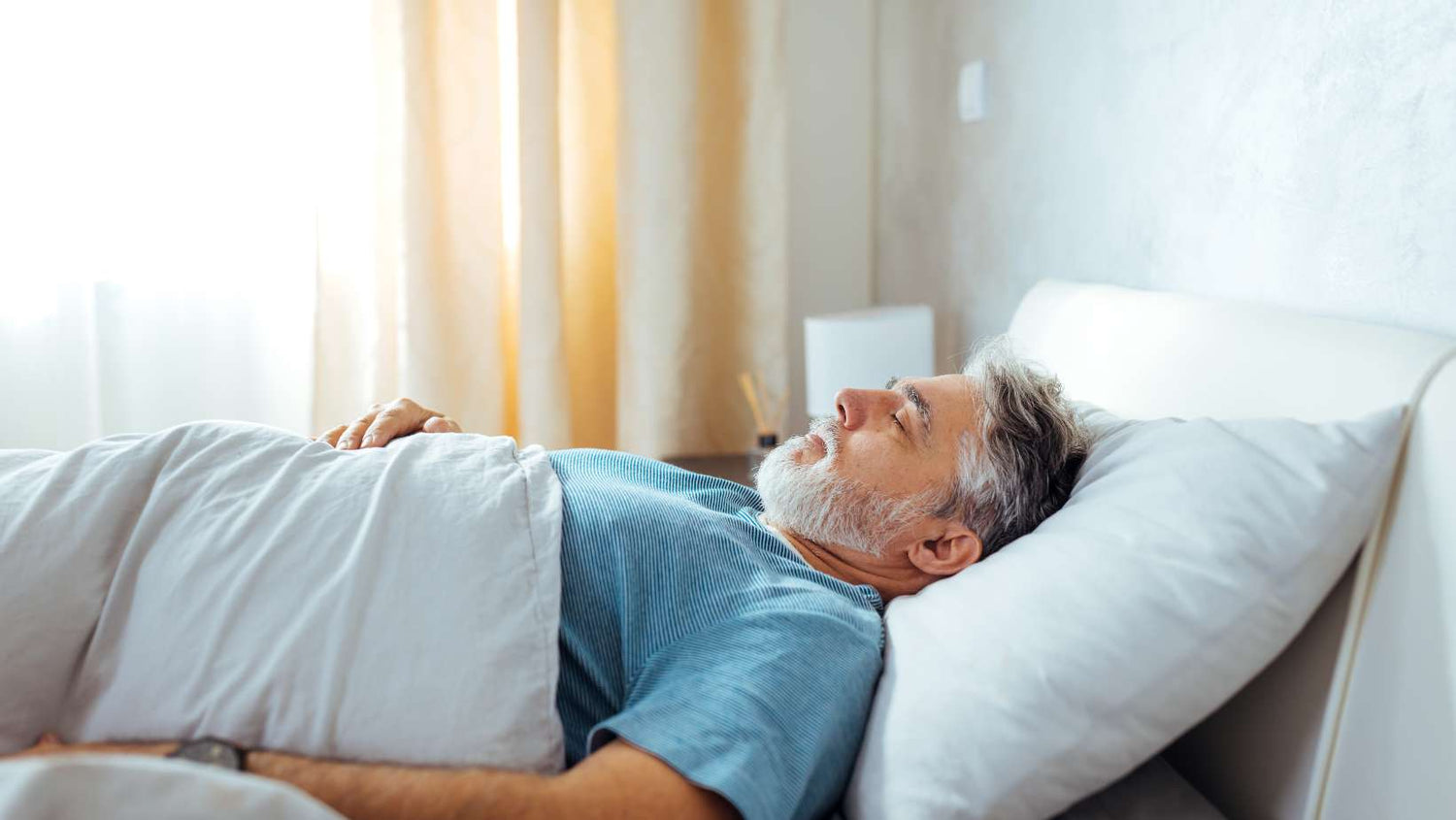 Sweet Dreams. Mature Caucasian Man Sleeping Peacefully in Bed
