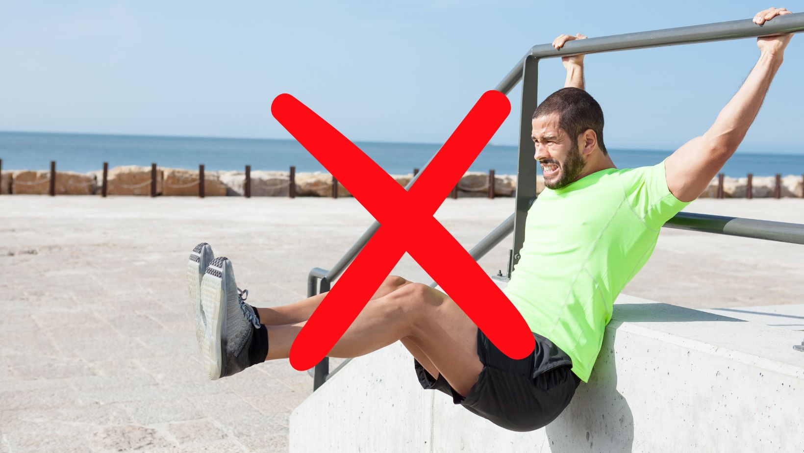Xed out picture of a guy doing hanging leg lifts
