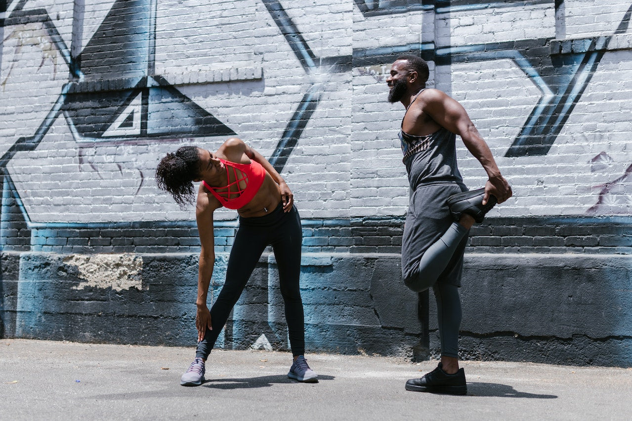 Two Fit People doing Stretching Exercises