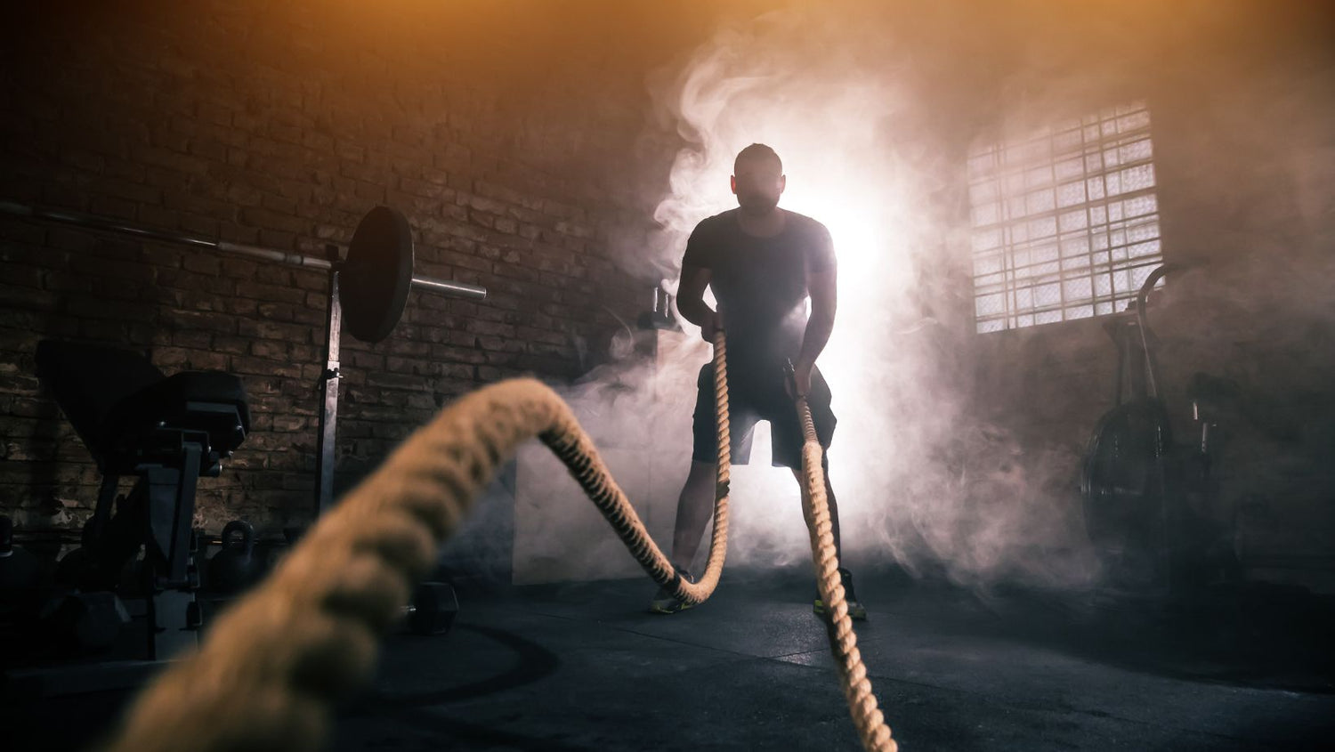 Young man doing hard exercise workout in gym