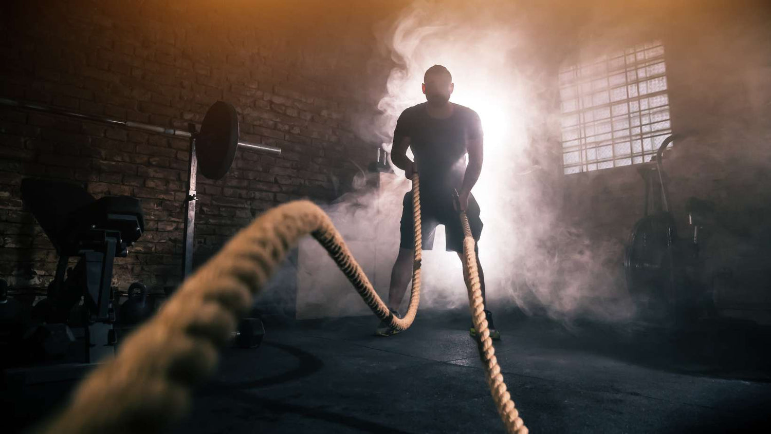 Young man doing hard exercise workout in gym