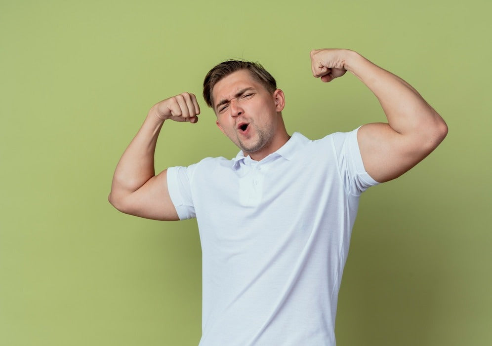 joyful young handsome male student doing strong gesture isolated on olive green background
