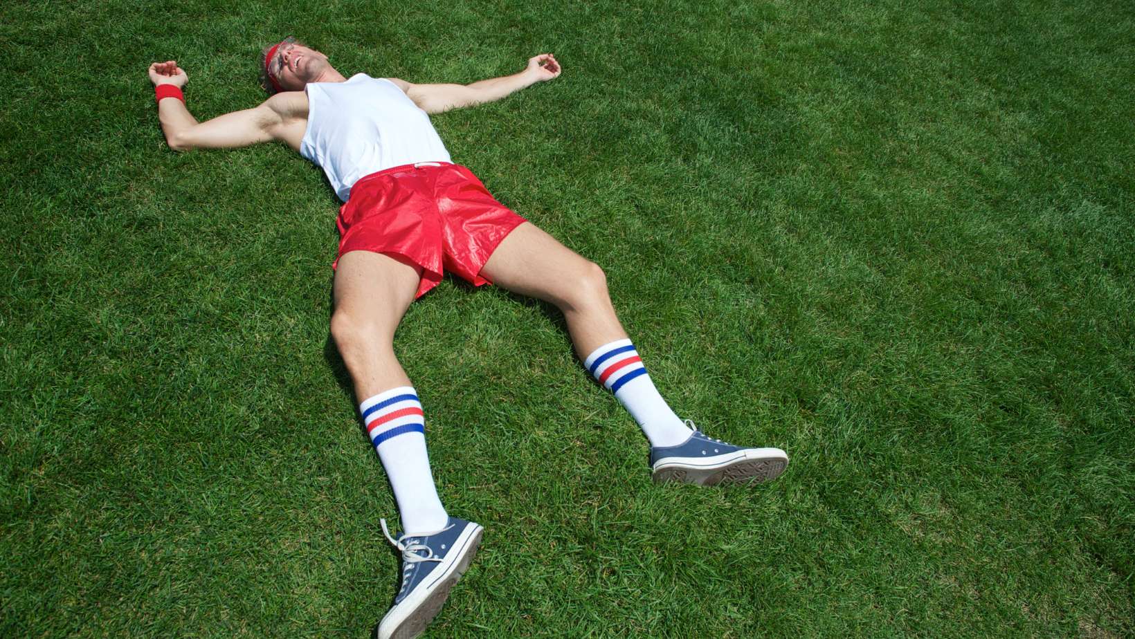 man with low testosterone laying flat on the ground