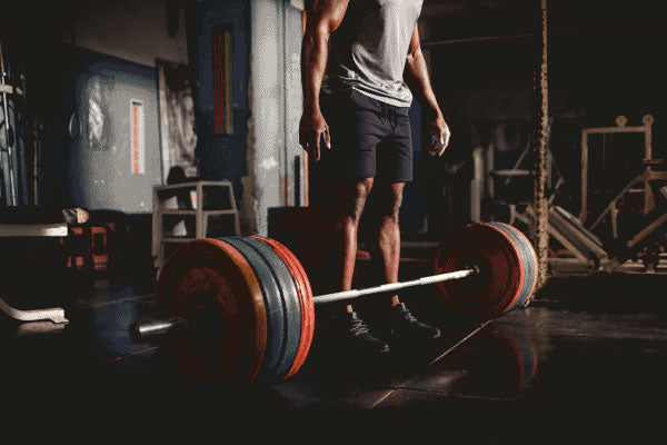 Man About to deadlift using Bodybuilding Supplements